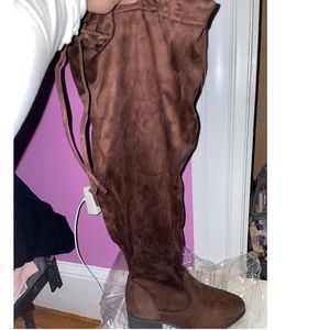 HANNAH brown knee high boots that tie in the back.